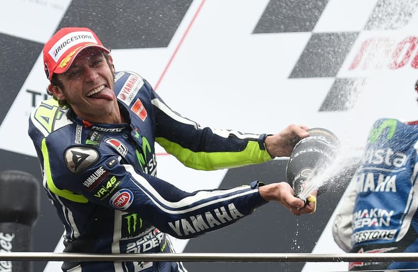 MotoGP rider Valentino Rossi of Italy celebrates winning the Australian MotoGP Grand Prix at Phillip Island on October 19, 2014. AFP PHOTO/Peter PARKS IMAGE STRICTLY RESTRICTED TO EDITORIAL USE - STRICTLY NO COMMERCIAL USE        (Photo credit should read PETER PARKS/AFP via Getty Images)